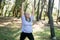 Mature elderly grey haired dreadlocks woman training in park, doing yoga or fitness - wellbeing and healthy lifestyle