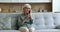 Mature elderly lady in glasses speaking on cellphone, getting happy