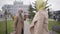 Mature elegant Caucasian women saying goodbye to her friend. Senior ladies in beige coats and sunglasses waving each