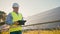 Mature engineer male working alone at professional solar station