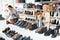 Mature european woman chooses autumn suede shoes