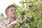 Mature farmer with hat picking berries at farm