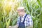 Mature farmer inspecting corncob at farm