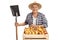 Mature farmer posing with shovel and crate of pears