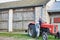 Mature farmer wearing hat and driving tractor