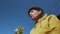 Mature farmer wearing hat eating grape harvest standing in vineyard.