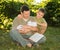 Mature father with a newborn baby in his hands reading book with