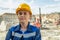 Mature female builder in hardhat looking at camera