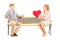 Mature female giving a red heart to a surprised man, seated on a