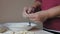 Mature female hands making dumplings with cheese at home kitchen