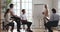 Mature female mentor teaching diverse employees group with flip chart