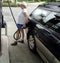 Mature female senior at the gas station.