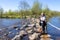 Mature female tourist with her dachshund standing on the stepping stones of the Brug Molenplas