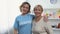 Mature female and young woman pointing at volunteer inscription on t-shirt