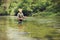 Mature fisherman fishing in a river