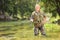 Mature fisherman posing with fishing rod in river