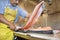 Mature fishmonger slicing salmon fish on table