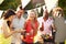 Mature Friends Enjoying Outdoor Summer Barbeque In Garden