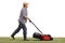 Mature gardener mowing a lawn