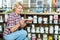 Mature glad woman customer picking various ribbon