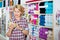 Mature glad woman customer picking various yarn