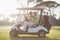 Mature golfer man pointing while sitting by friend