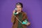 Mature grey haired woman chatting or gossiping on the phone holding retro telephone handset wearing velveteen jacket