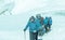 Mature Guide leading Group of Mountain Climbers on Glacier toned