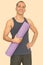 Mature happy Persian man holding yoga mat getting ready for gym