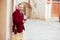 Mature happy smiling man with glass of red wine outdoors in old italian village