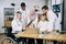 Mature head doctor in wheelchair with colleagues at office