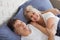 Mature heterosexual beautiful couple lying on bed in bedroom