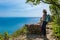 Mature hiker looking the sea. Travel and active lifestyle concept.