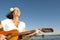 Mature hippie woman with guitar