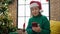Mature hispanic woman with grey hair doing christmas online shopping with smartphone at home