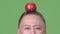 Mature Japanese businessman with apple on head