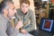 Mature joiner in contemplation while in discussion with female colleague