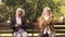 Mature ladies sitting separately on bench in park, friends argued and quarreled