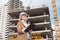 Mature lady architect supervises work at construction site