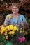 Mature lady working flowers outside portrait