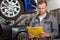 Mature male auto mechanic working at the garage