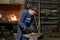 Mature male blacksmith at work