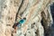 Mature male Climber making risky Move on dangerous Rock