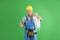 Mature male electrician showing thumb-up gesture on color background