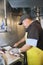 Mature male fishmonger cutting fish on table