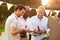 Mature Male Friends Enjoying Outdoor Summer Barbeque