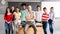 Mature male high school teacher with his multiracial group of teen students looking at camera. Horizontal banner image