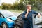 Mature Male Motorist Involved In Car Accident Calling Insurance Company Or Recovery Service