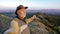 Mature male tourist stands on the top of Akbura mountain and enjoys the beautiful view of the Ural mountains at the autumn