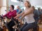 Mature males and females on exercise bikes in the gym